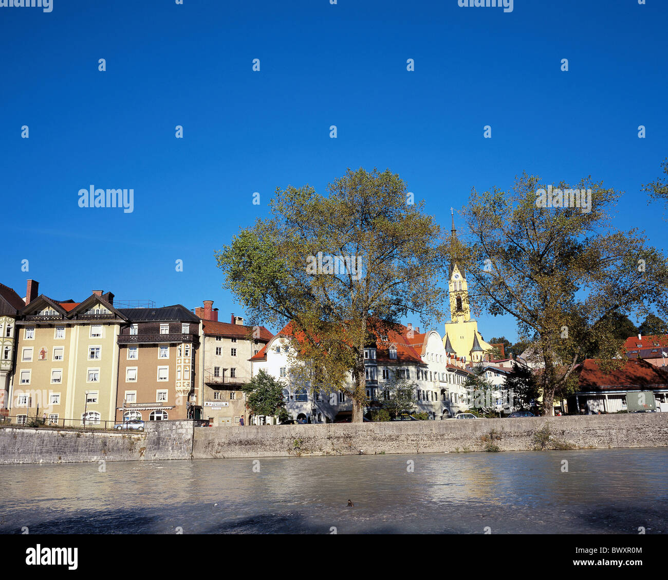 Germany Europe Bavaria bath Bad Tolz Old Town church houses homes river flow cutting part Stock Photo