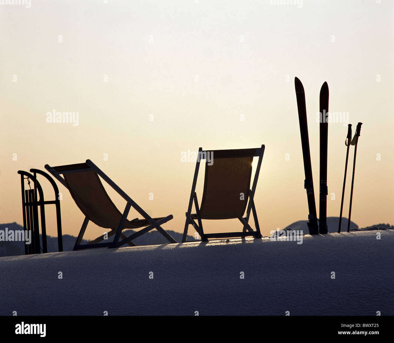 evening mood spare time Switzerland Europe deck chairs sledges sleighs ski winter ski winter sports sport Stock Photo