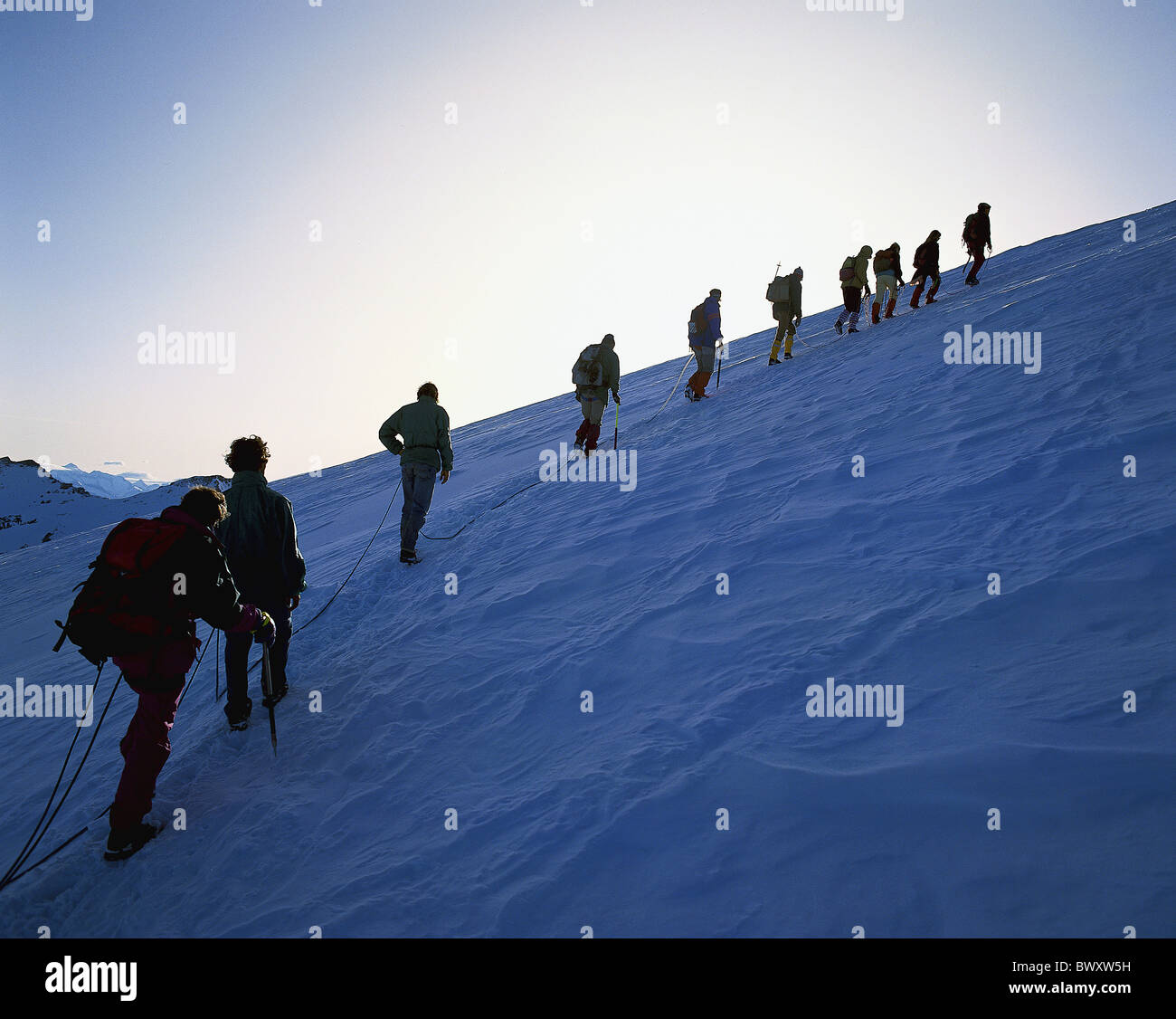 rope Switzerland Europe group persons evening mood anseilen mountaineering sport glacier big great group Stock Photo