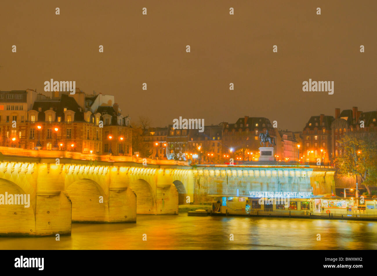 Paris night scene with Pont Neuf and boat restaurant Stock Photo