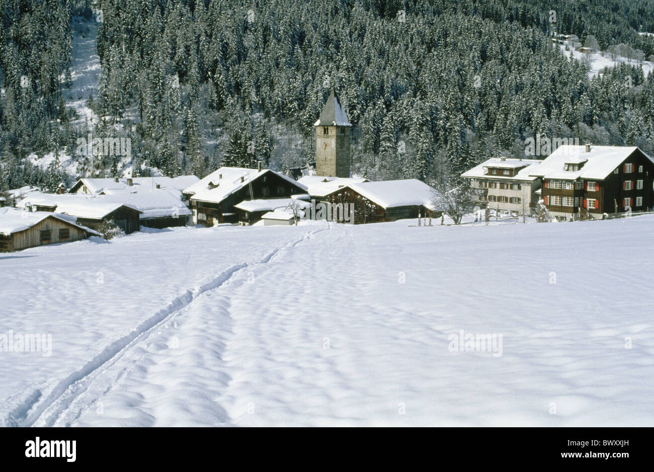 Graubunden Grisons houses homes church cloister Switzerland Europe winter Stock Photo