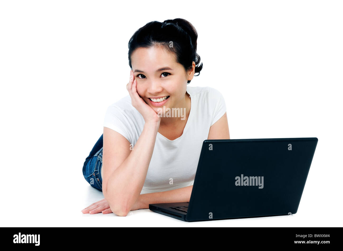 Beautiful woman lying on floor with a laptop Stock Photo - Alamy
