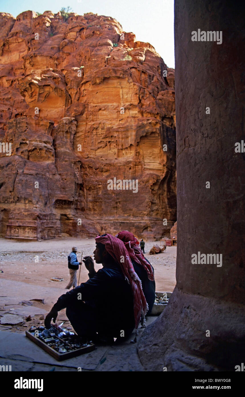 Two Bedouins sitting at the entrance to El Khazneh Treasury, Petra, Jordan. Stock Photo