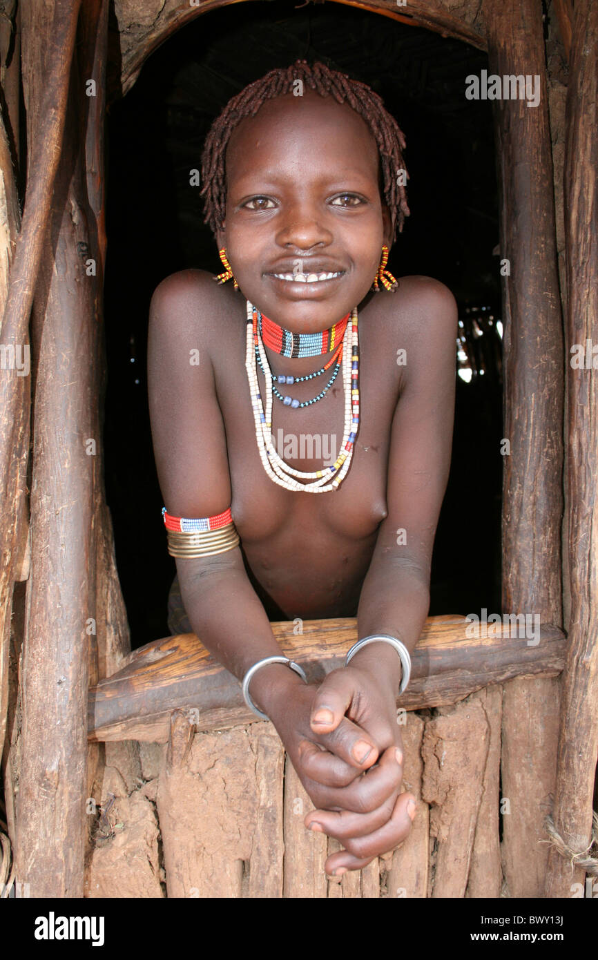 Hamer Tribe Girl At The Window Of Her Hut, Boryani, Omo Valley, Ethiopia Stock Photo