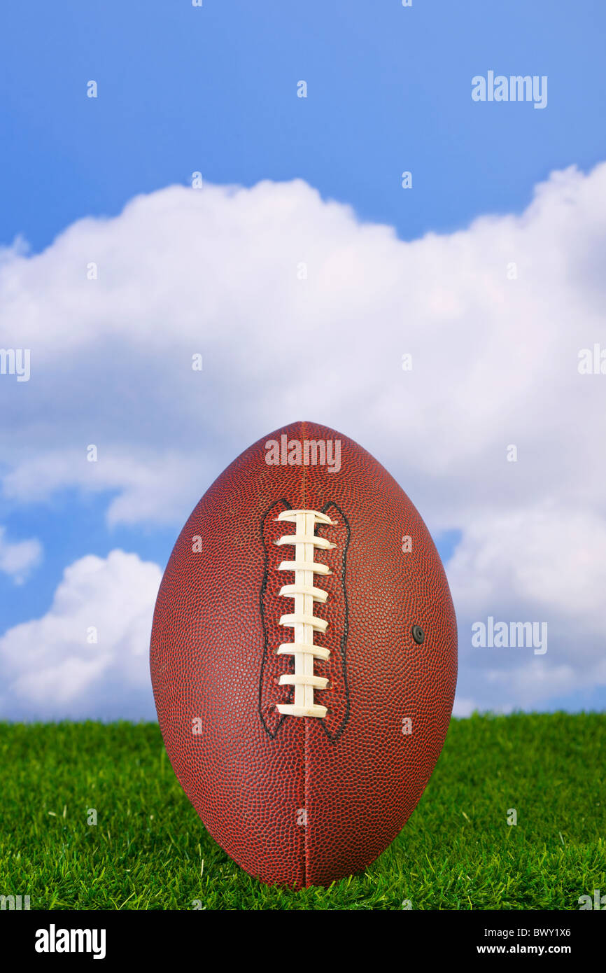 Photo of an American football tee'd up on the grass Stock Photo