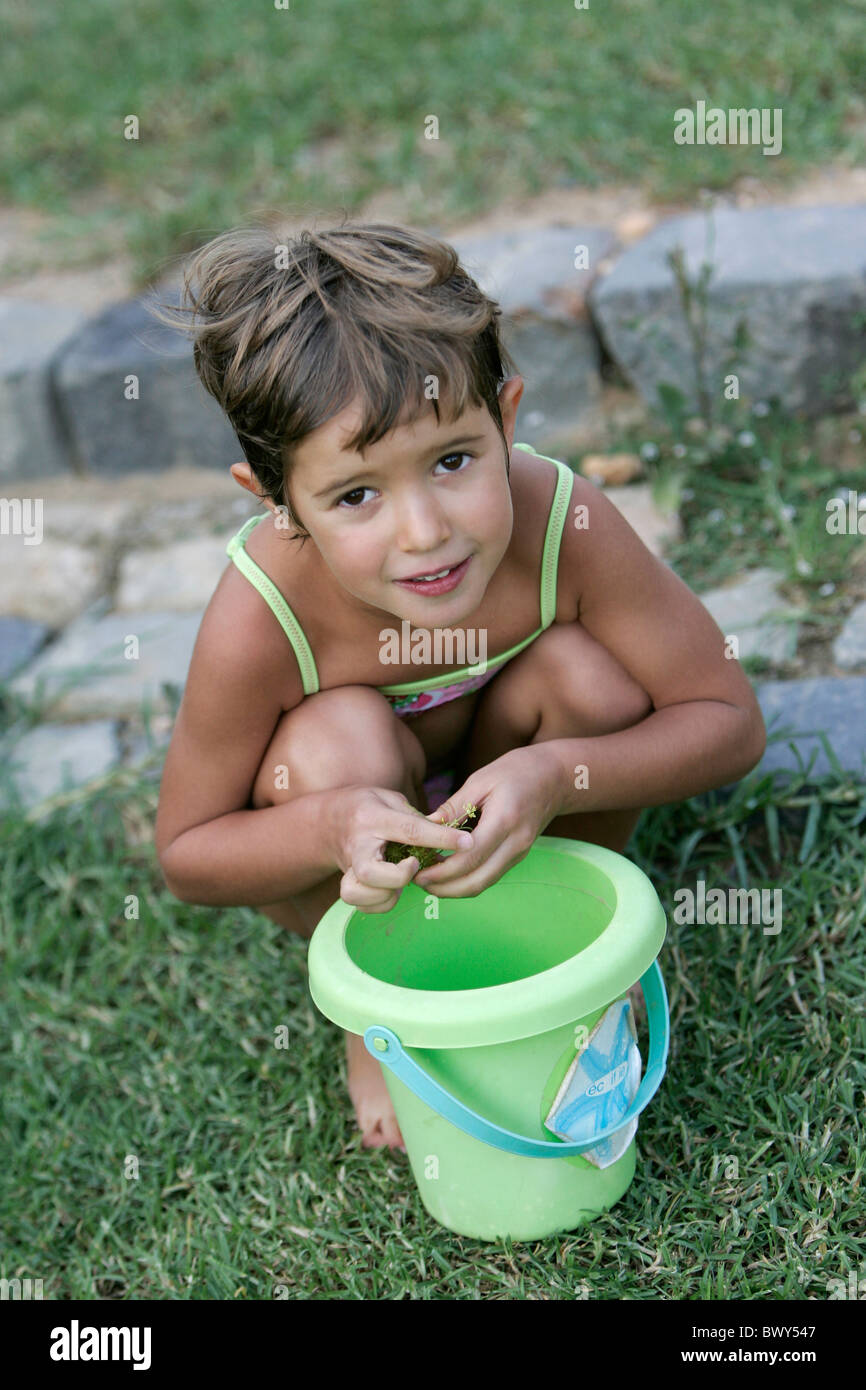 Portrait of a young girl playing in her garden Stock Photo