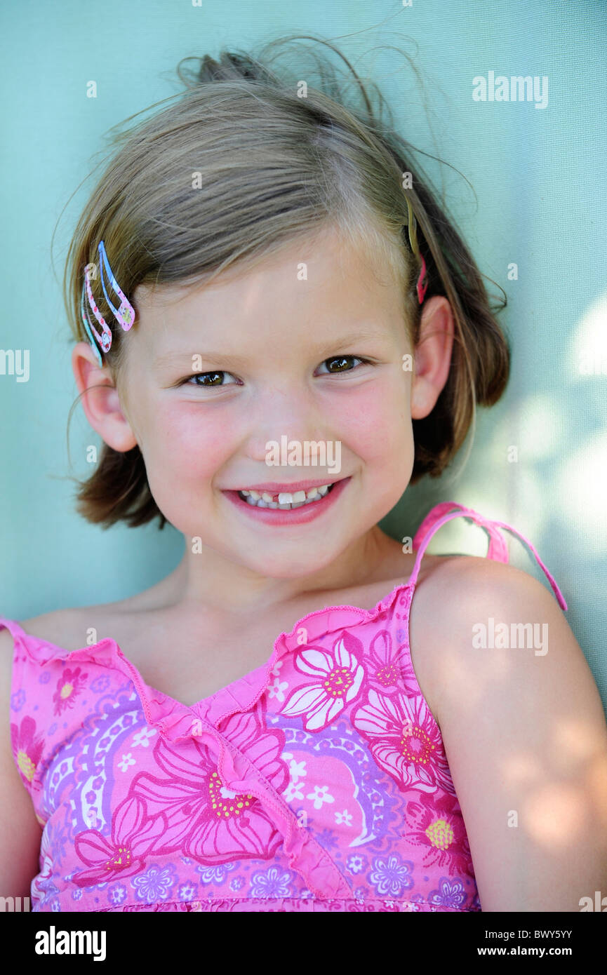 A young girl with a pink dress relaxing in a garden Stock Photo - Alamy