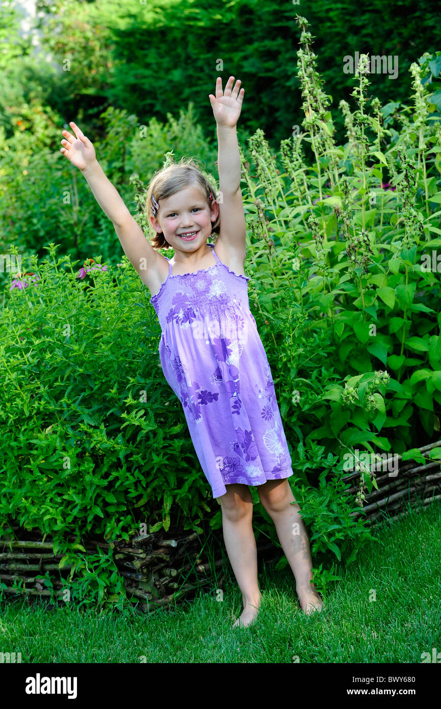 A young girl playing in a garden Stock Photo