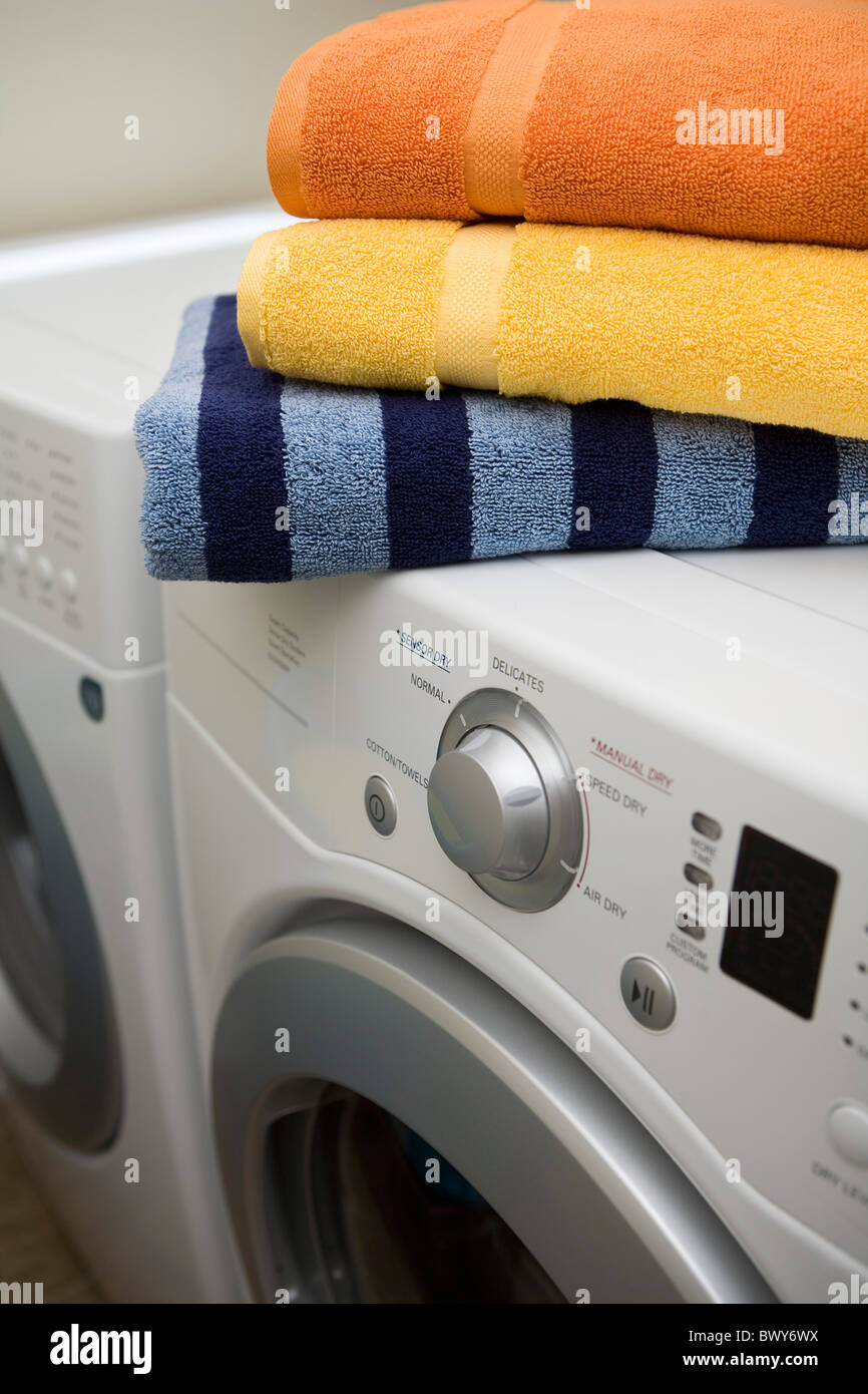 stack of towels on top of washer and dryer Stock Photo Alamy