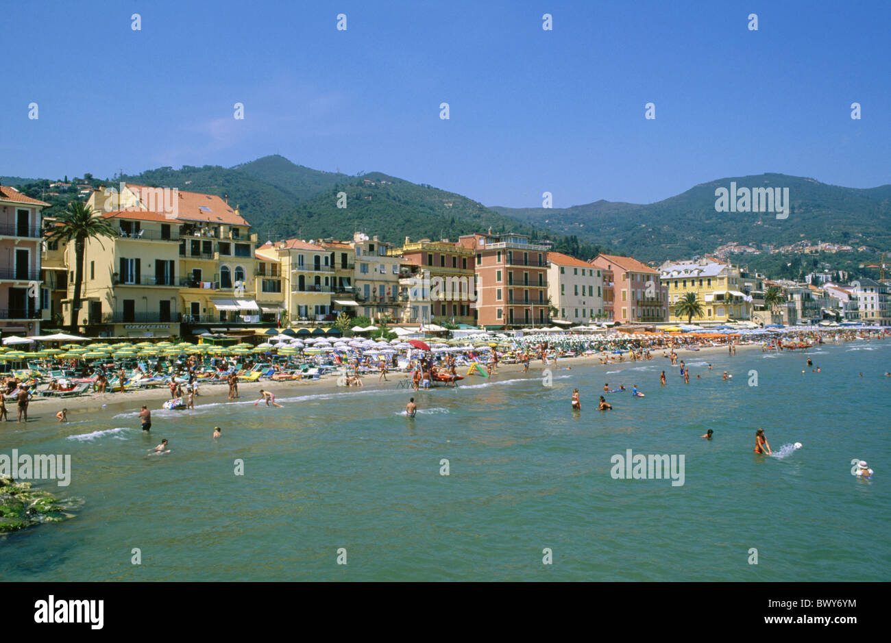 Alassio bathing Bagnos house line Italy Europe sea Riviera di Ponente sunshades beach seashore overcrowds Stock Photo