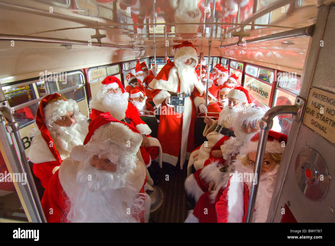 A busload of Father Christmases Stock Photo
