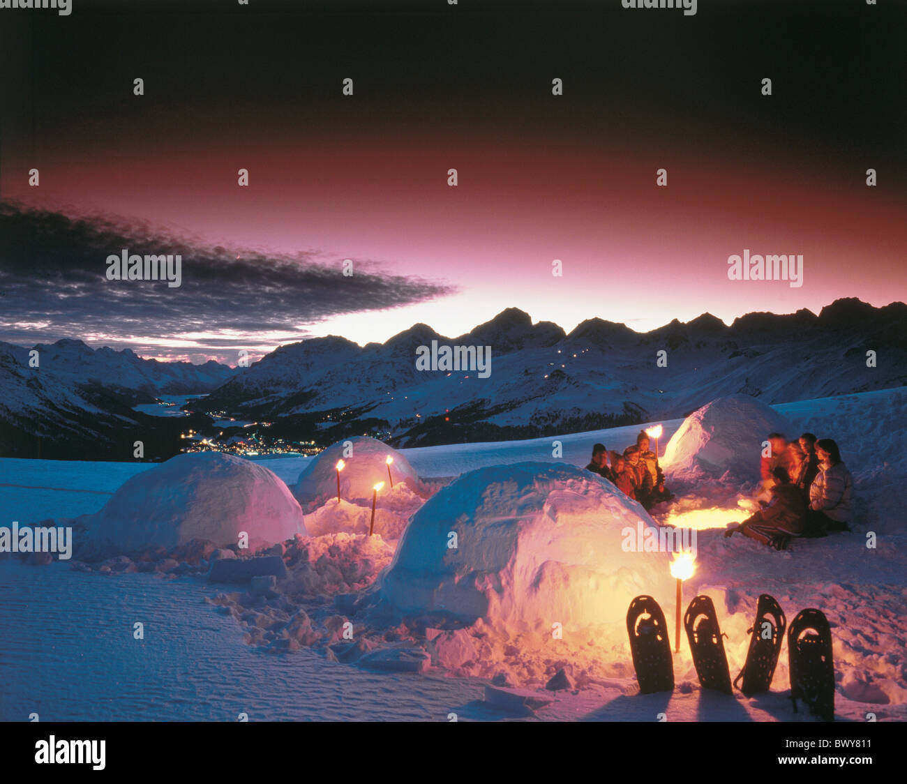 at night campfire dusk Engadine fire Graubunden Grisons group igloo mood mountains night romantical sce Stock Photo