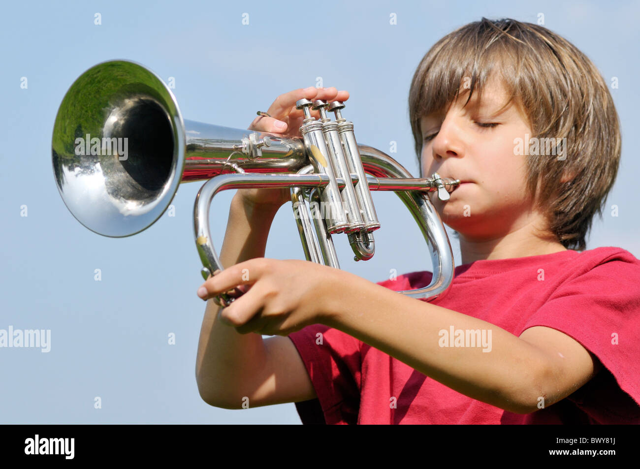Boy Playing Trumpet Stock Photo