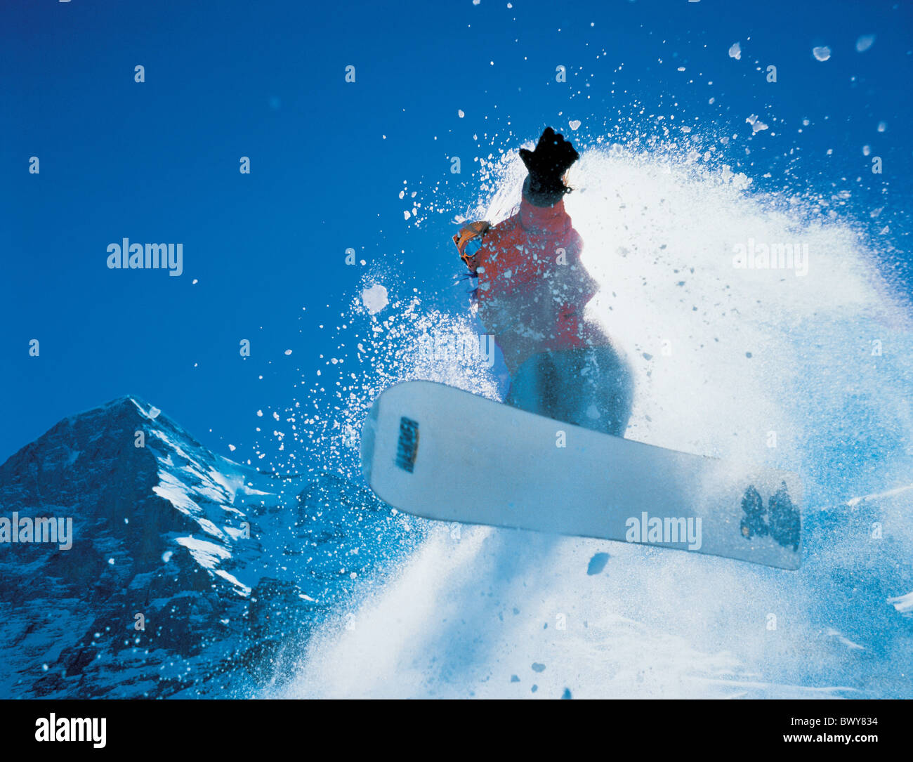 action jump jumping mountains snow snowboard Snowboard Snowboarder sports sun winter Stock Photo