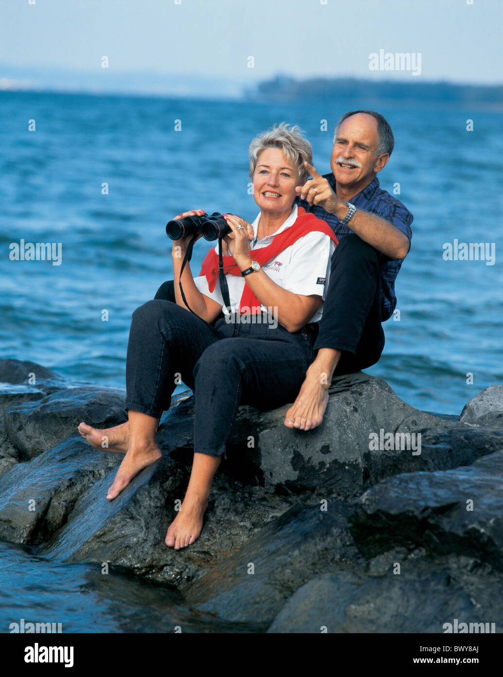 Two Laughing Rocks binoculars coast couple field glasses laugh rocks laughing middle age ...