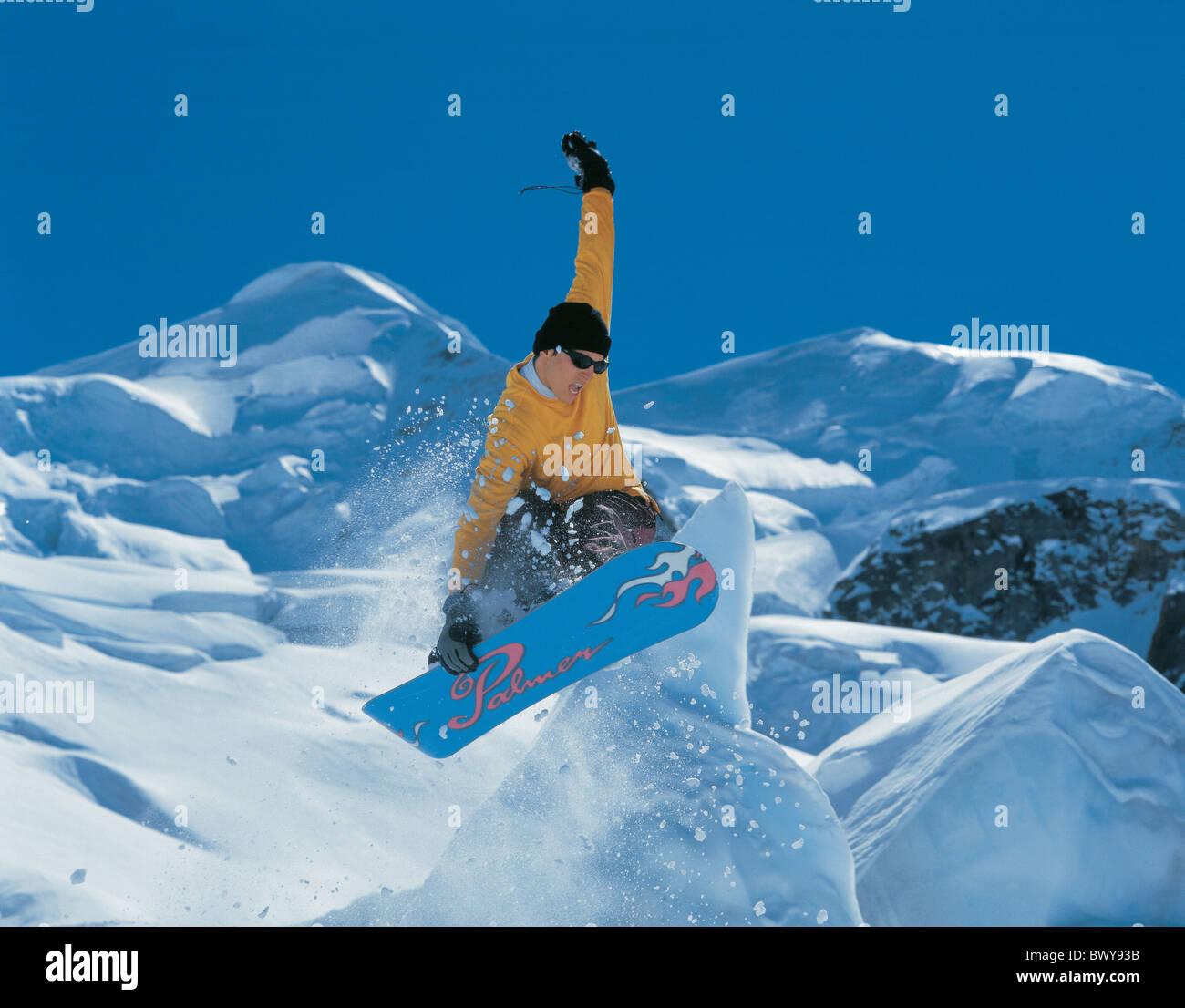 action jump man mountains snow snowboard Snowboarder spare time sports Alps winter sports winter Switzer Stock Photo