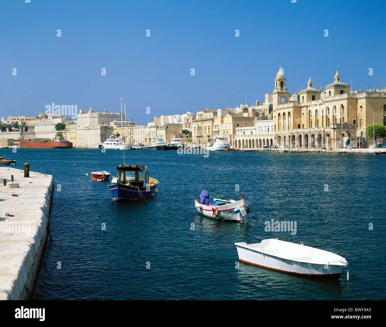 boats dock yard Creek harbour port Malta ships Valletta Vittoriosa houses homes tourism Stock Photo