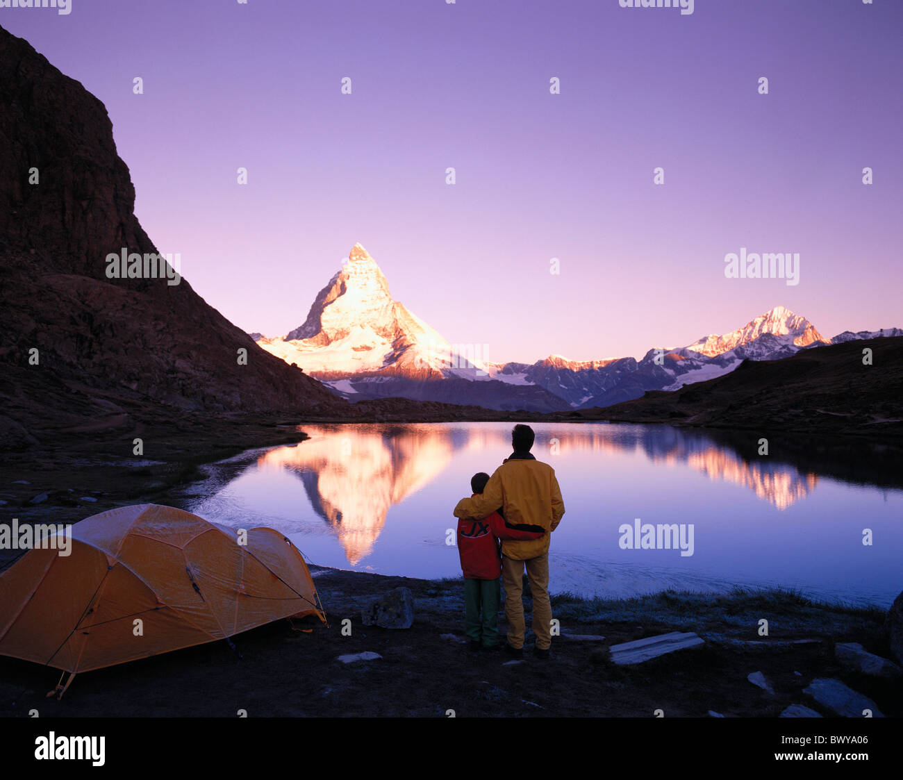 camp camping tents alpine Alps mountains camping dusk twilight canton Valais Matterhorn landmark mountai Stock Photo