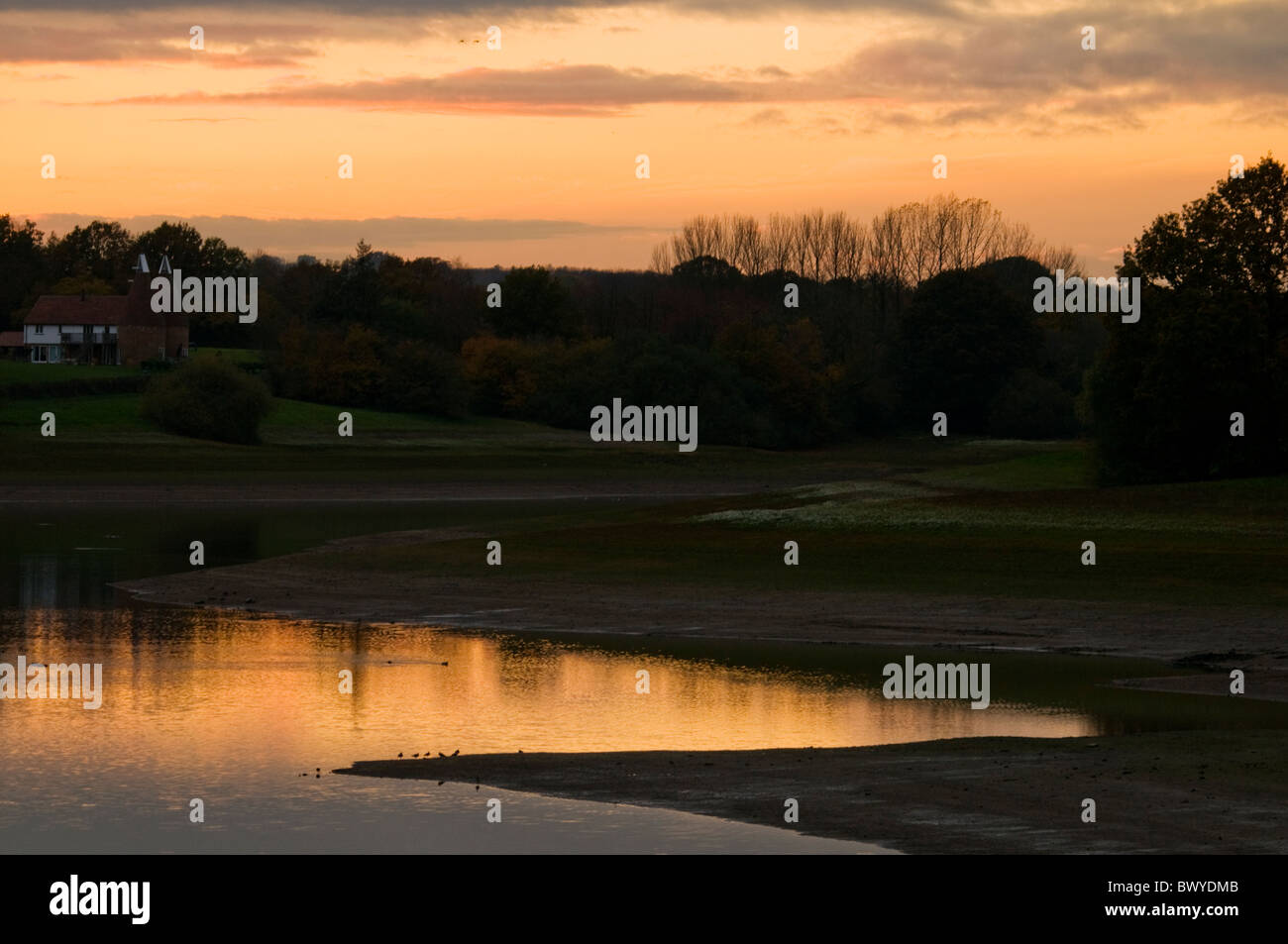 peachyorange sunset sky with landscape of bank and zigzag water reflecting BWYDMB