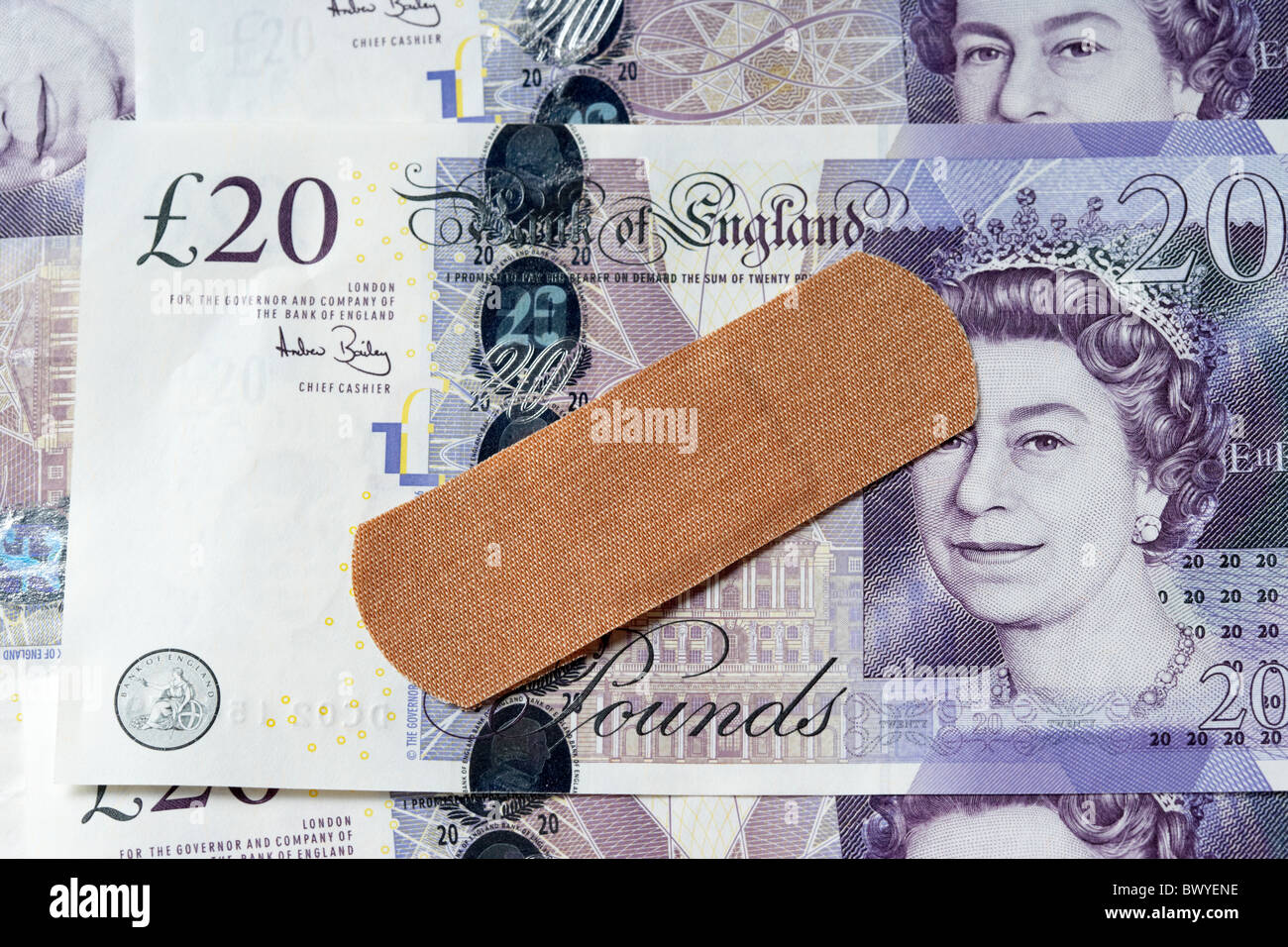 sticking plaster on british 20 pound notes Stock Photo