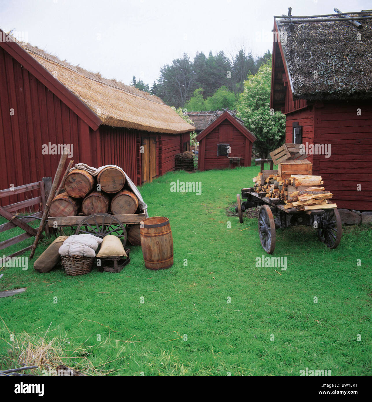 village barrels houses homes historical timber houses huts carts reed roof Sweden Europe settlement Sigt Stock Photo