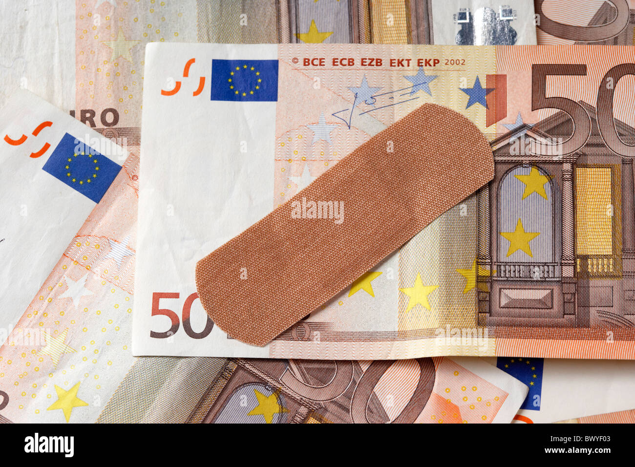 sticking plaster on 50 euro notes Stock Photo