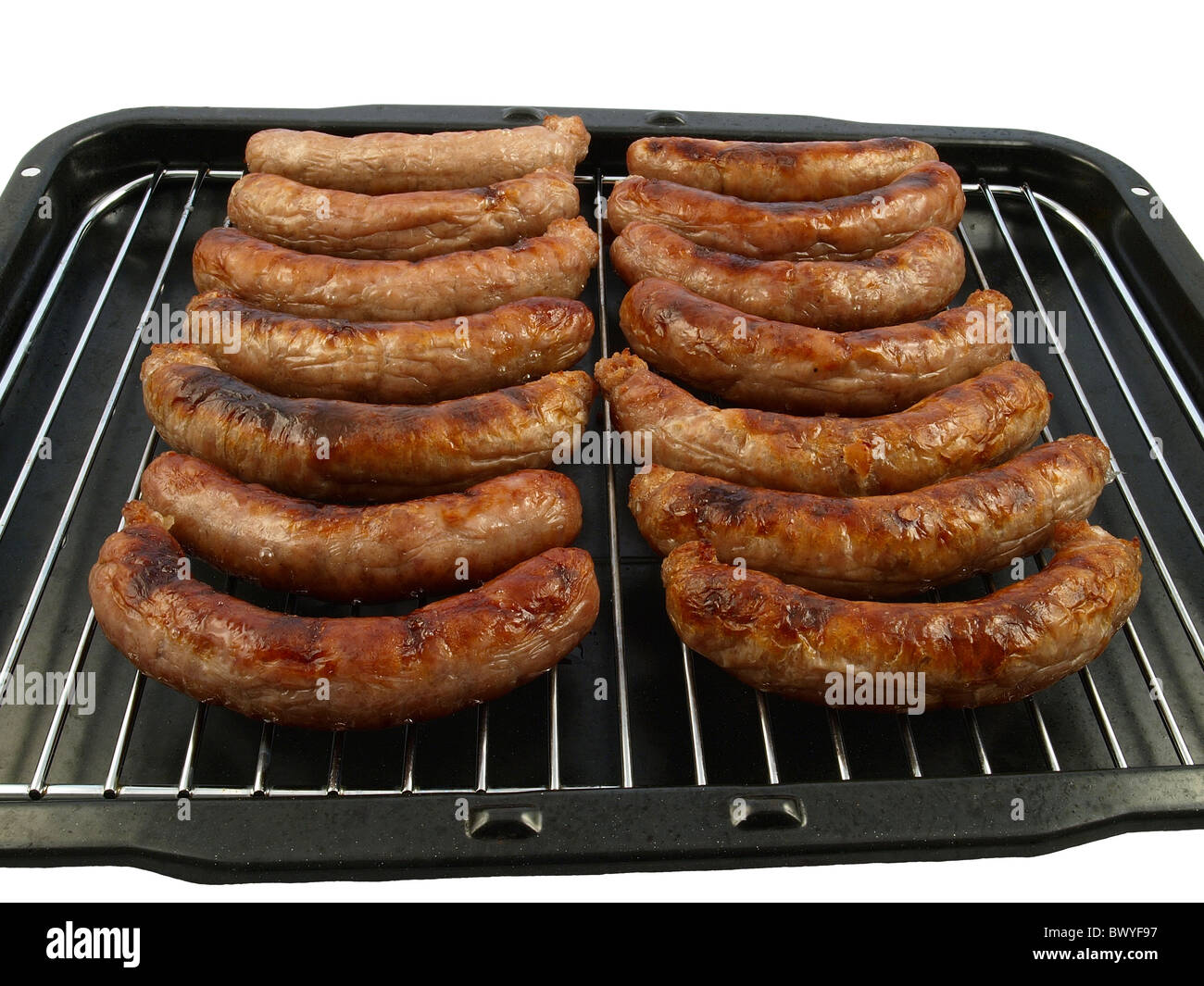 A grill pan of cooked pork sausages - isolated on white Stock Photo