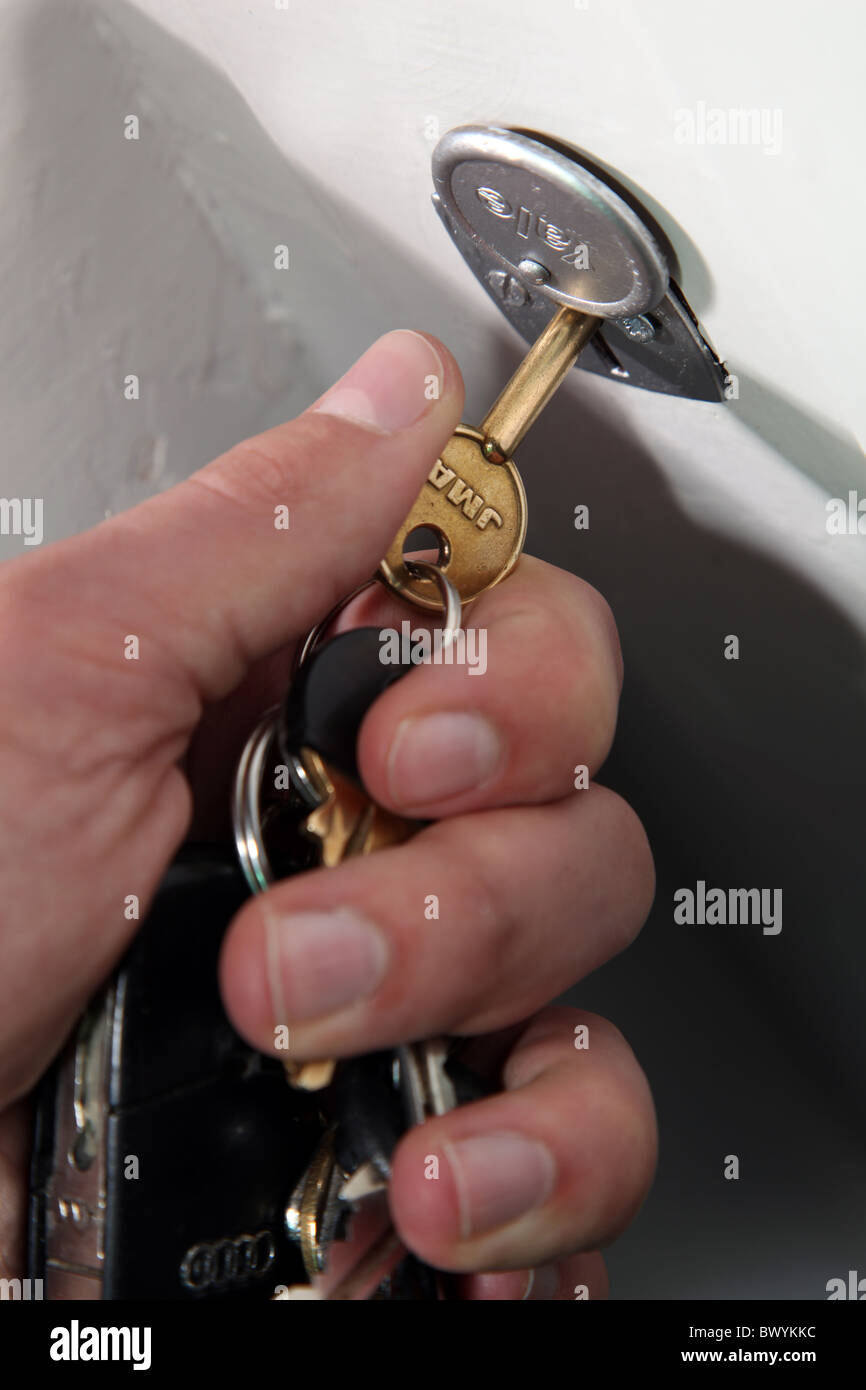 Hand turning a key in an internal door lock Stock Photo