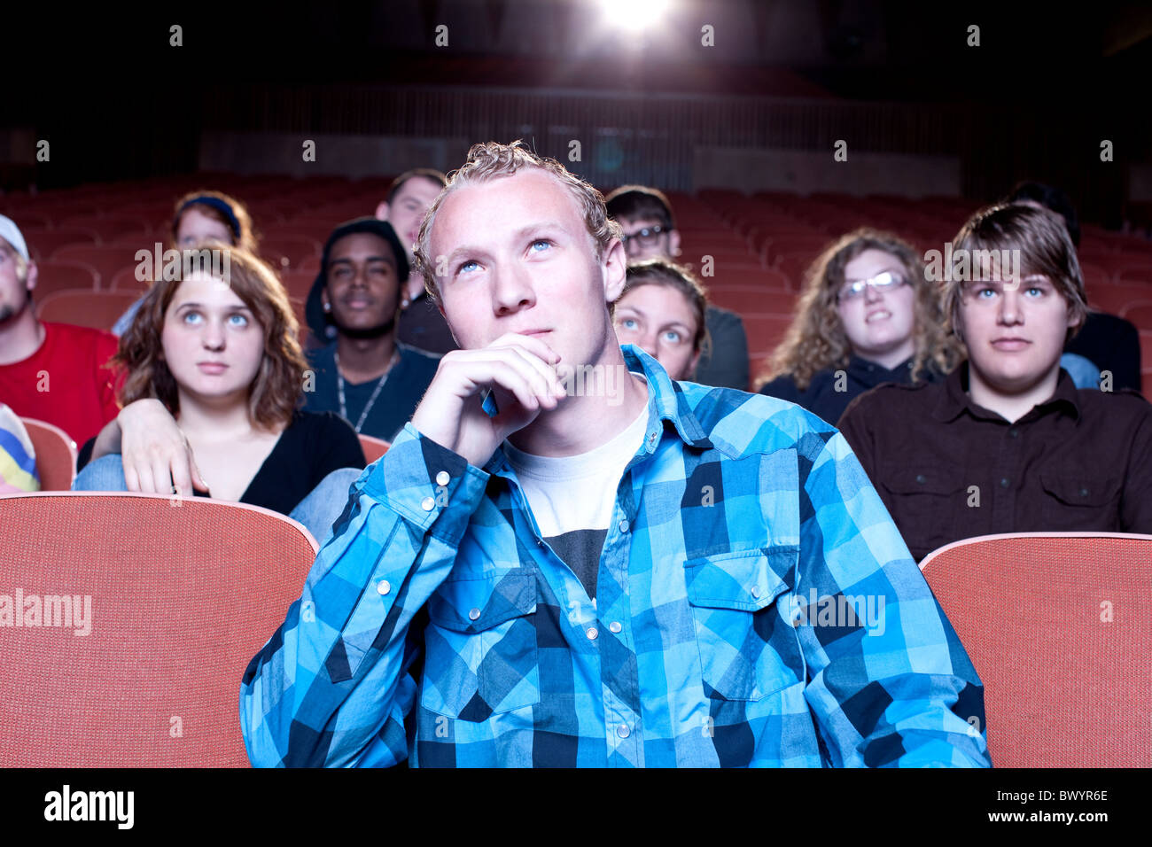 Caucasian man watching movie in theater Stock Photo