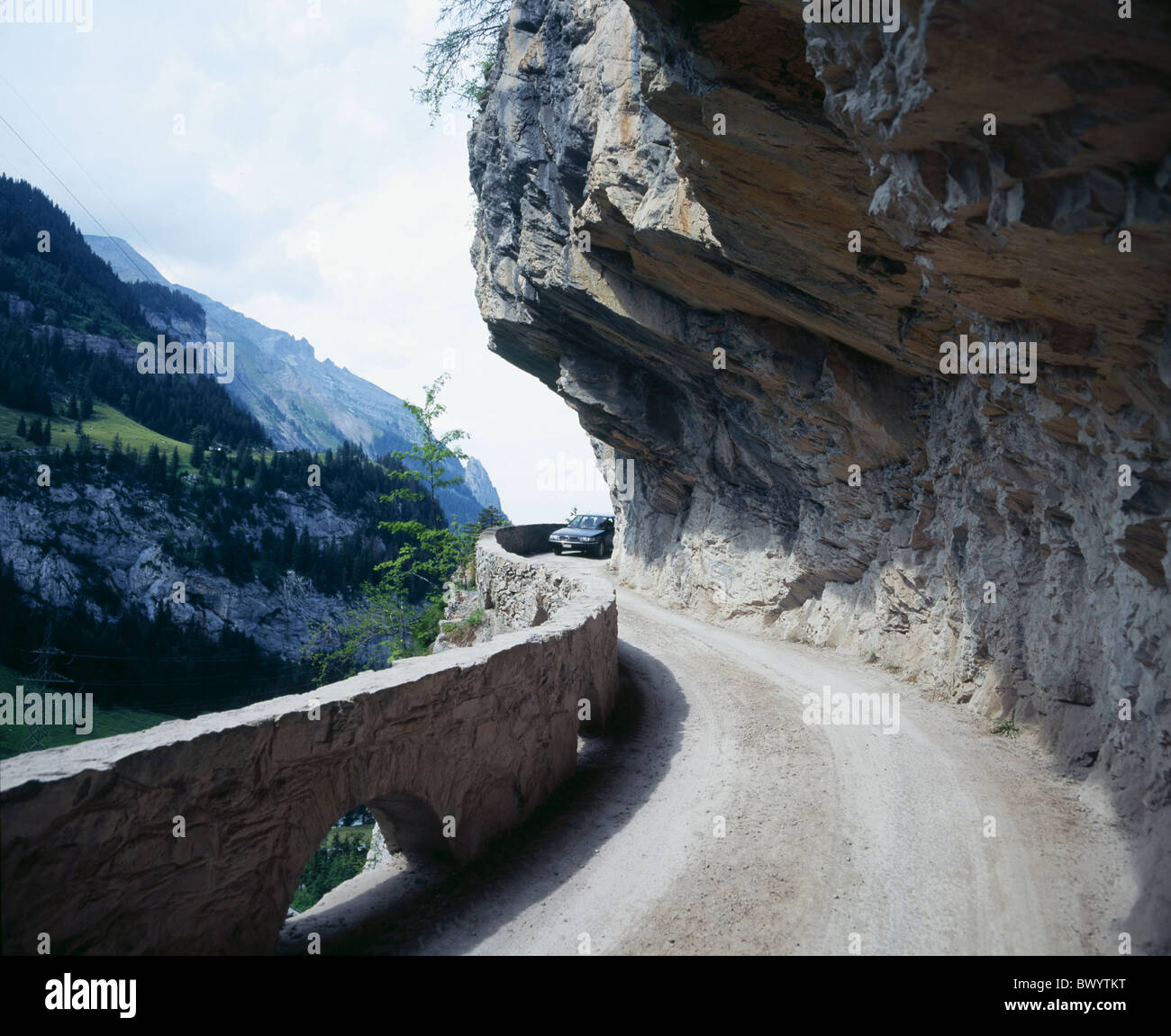 alpine Alps car automobile mountains mountain road Bernese Oberland narrowly tightly rocks cliffs Gastern Stock Photo