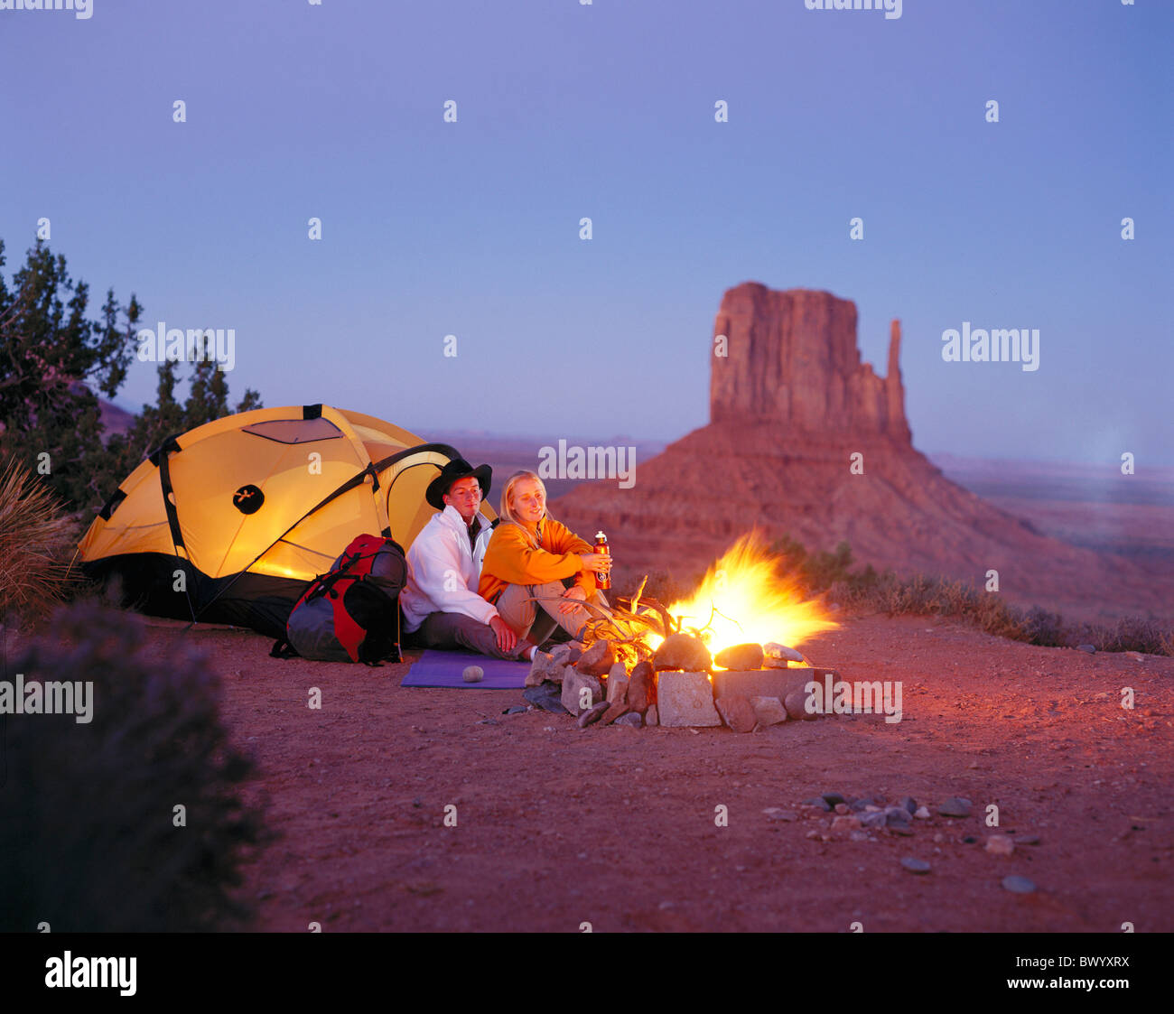 tents camp campfire monument Valley at night pair couple romantical teenager USA America North America t Stock Photo