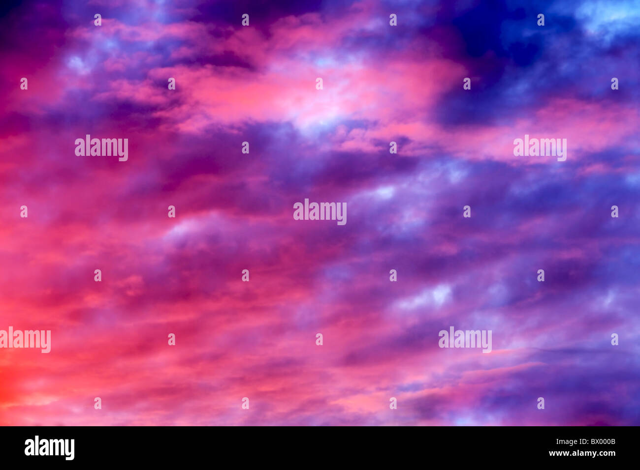 Great sunset sky with clouds all possible shades of pink and purple, great nature background. Stock Photo