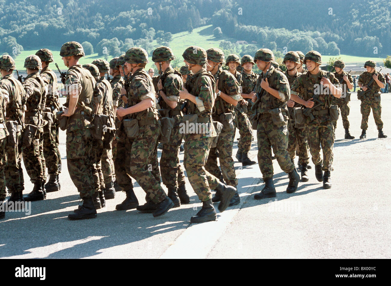 army military group men marsh march marching military no model release Switzerland Europe soldier unifor Stock Photo