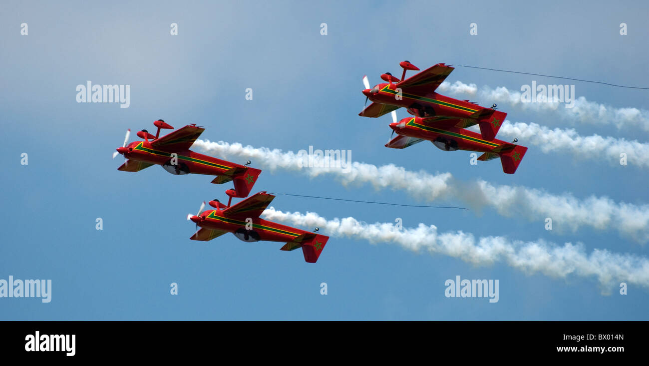 Four 4 Royal Moroccan Air Force aerobatic display team Marche Verte Green March CAP-231 planes flying inverted with smoke wires Stock Photo