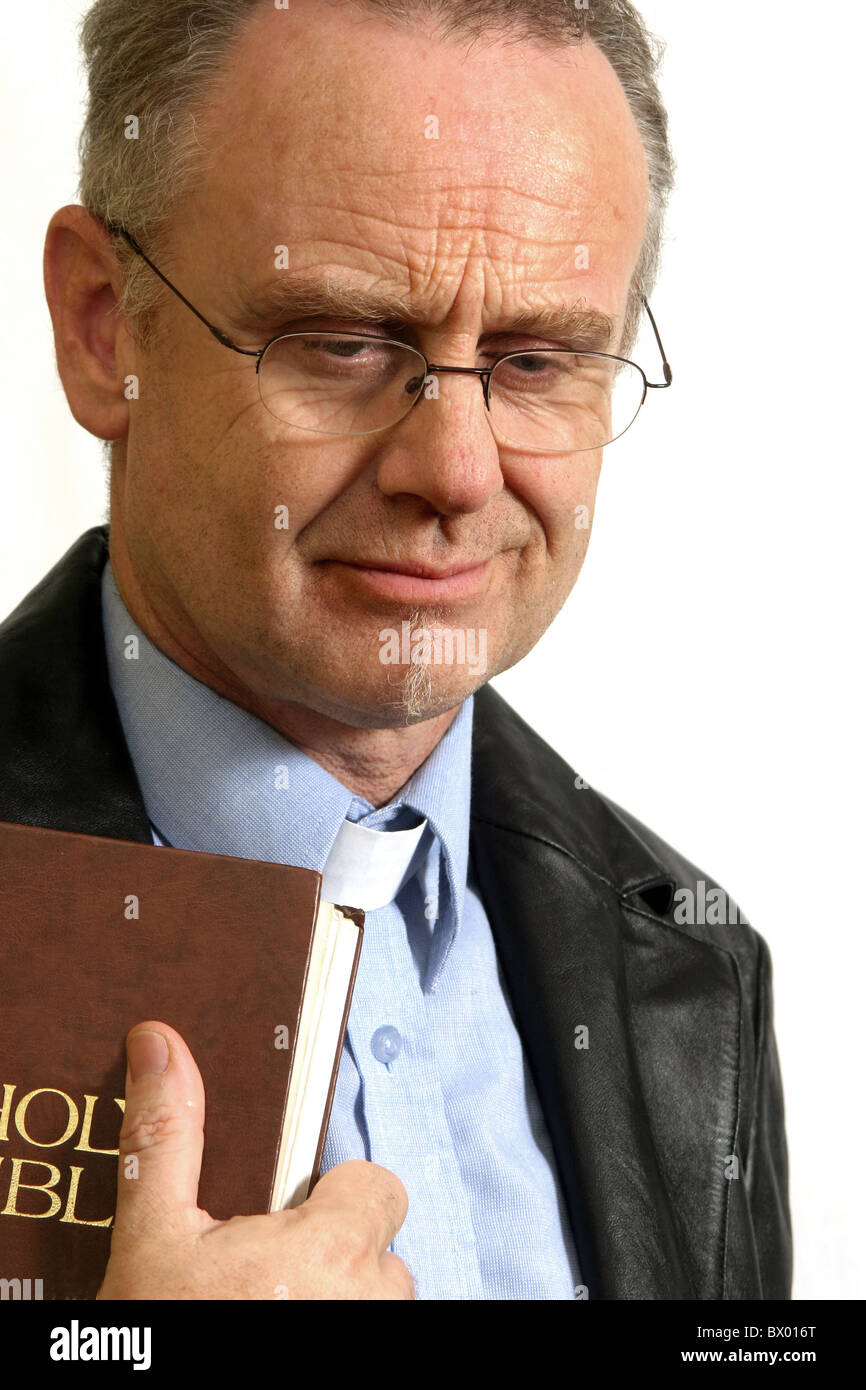 November 2005 Mature vicar holding his bible Stock Photo Alamy