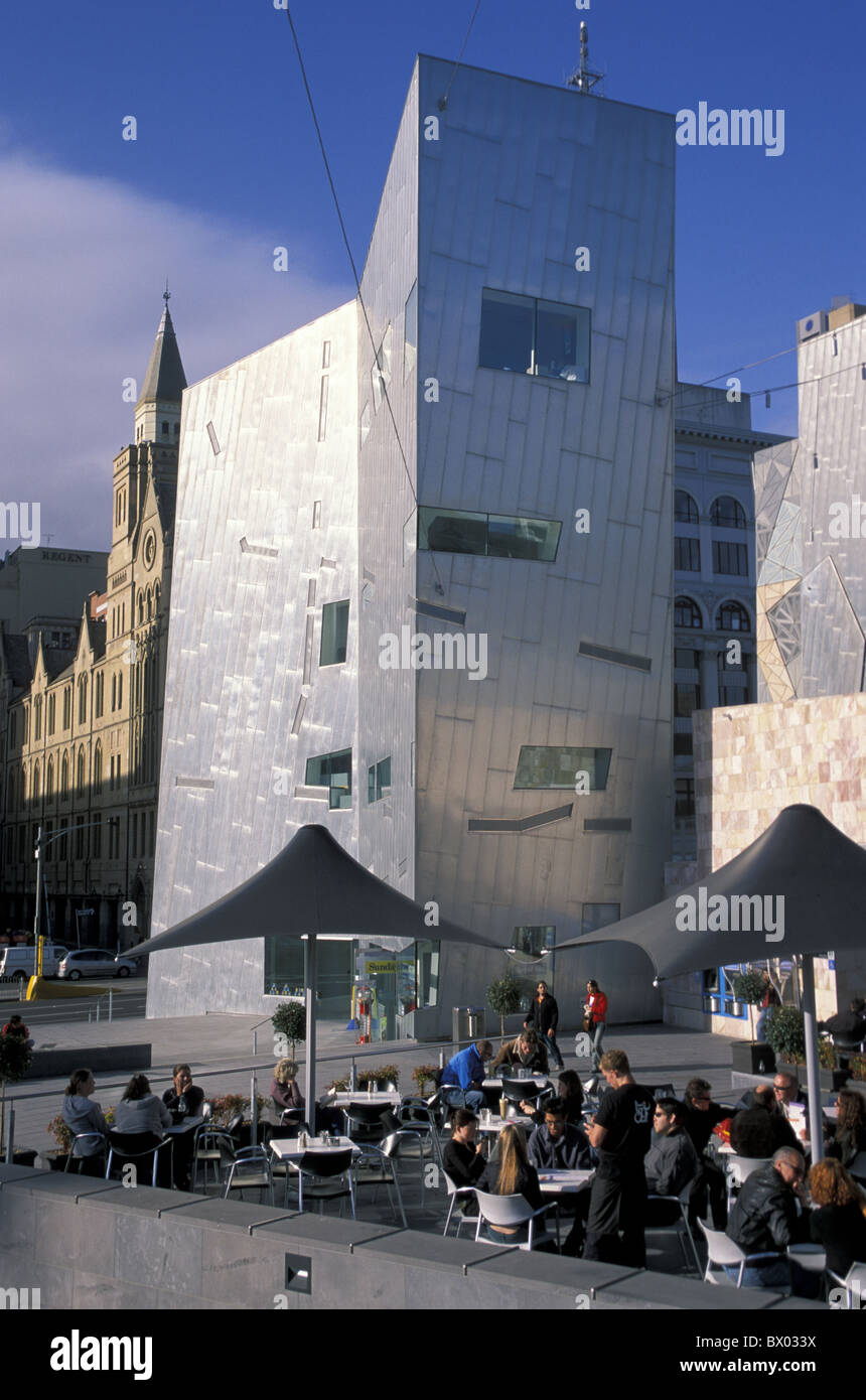 Australia Federation Square Melbourne Victoria people modern passerby cafe sidewalk cafe architecture buil Stock Photo