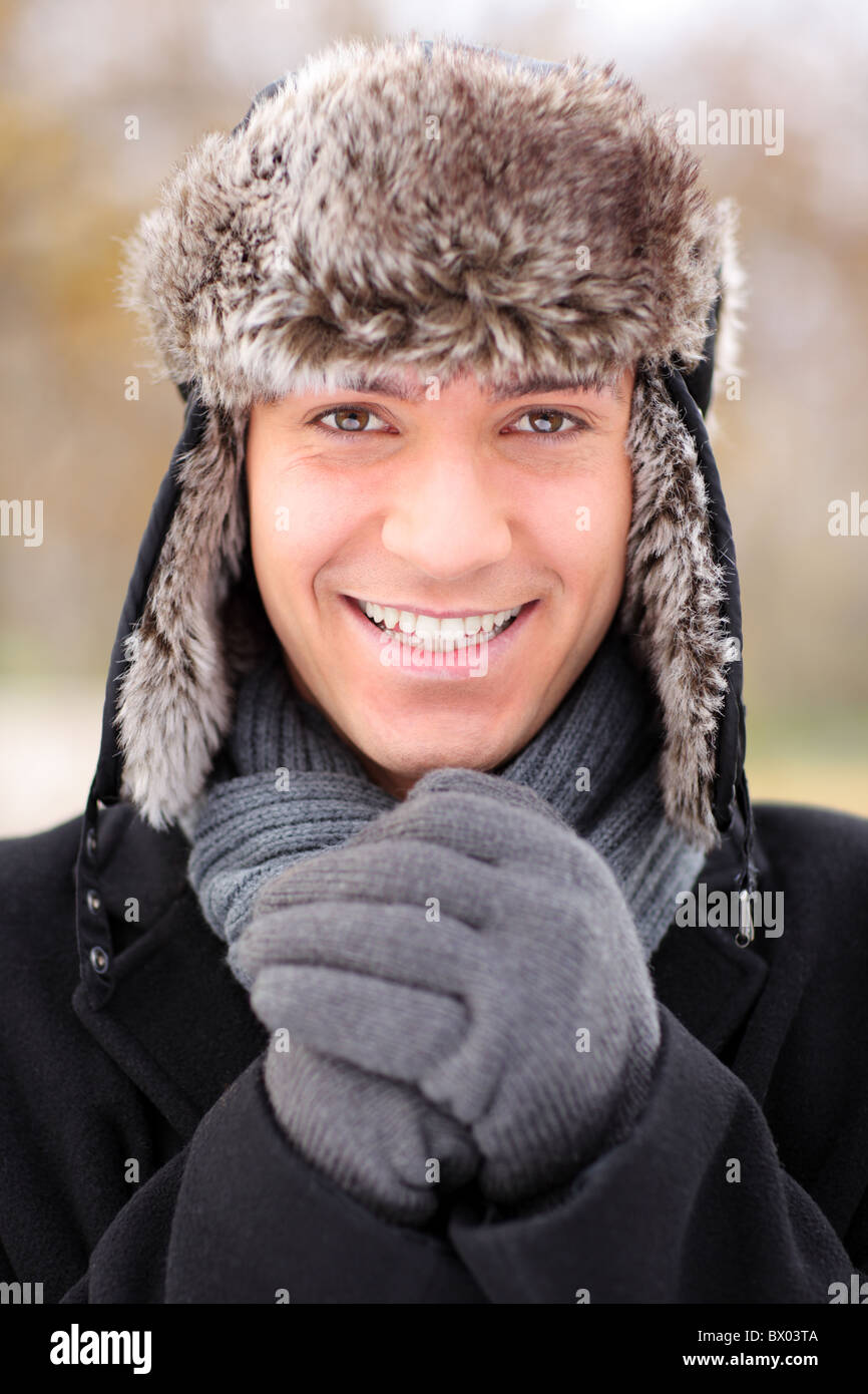A happy smiling man wearing a fur trendy hat Stock Photo
