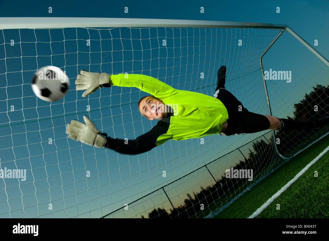 Caucasian goalie deflecting soccer ball Stock Photo Alamy