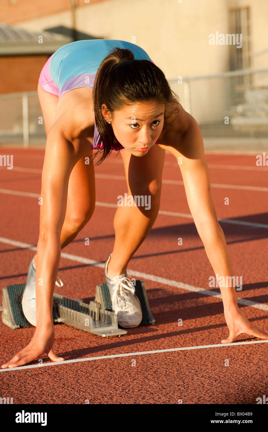 Japanese runner preparing to start race on racetrack Stock Photo