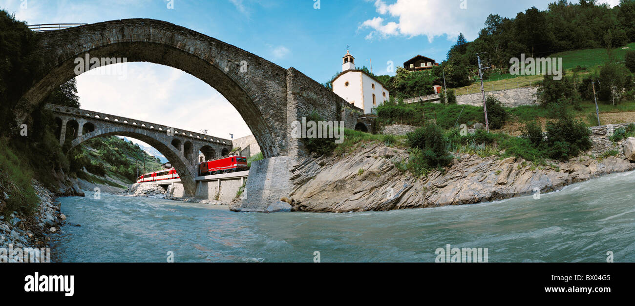 old stone bridge railway Glacier express train canton Valais church Neubruck panorama SBB Switzerland Eur Stock Photo
