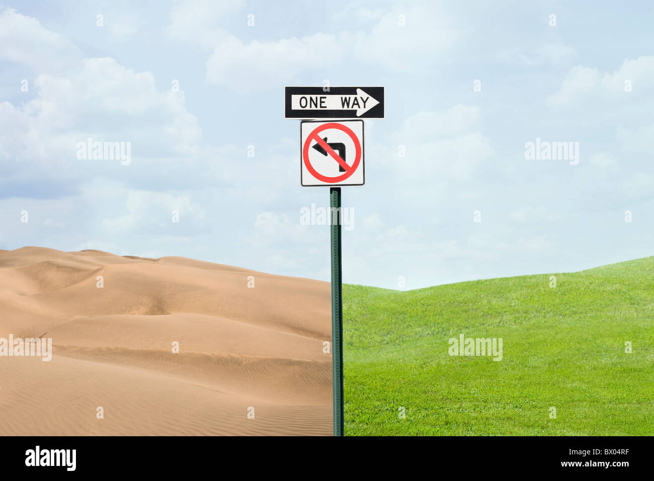 Road signs pointing at green grass and desert Stock Photo