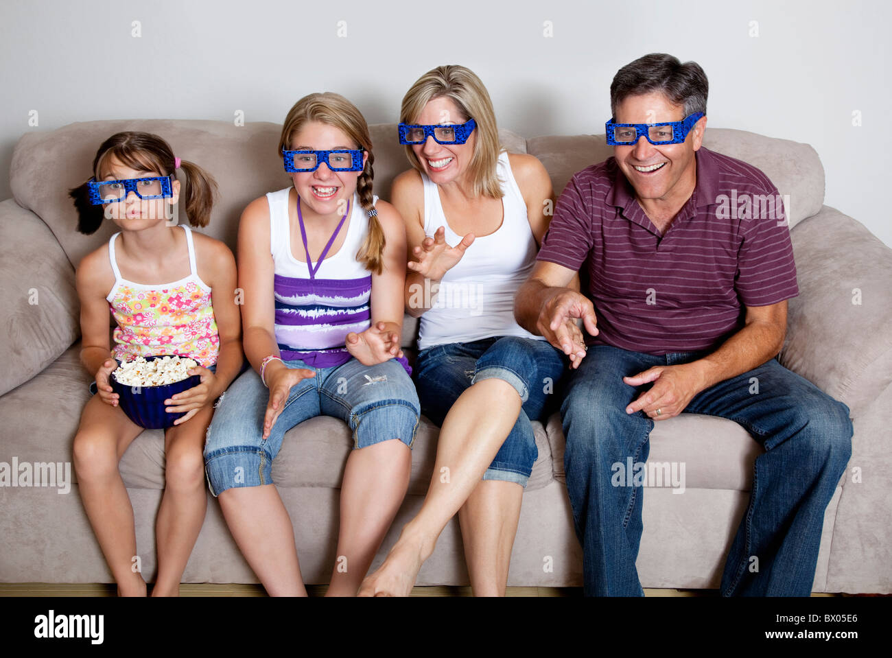 Caucasian watching television with 3d glasses Stock Photo Alamy