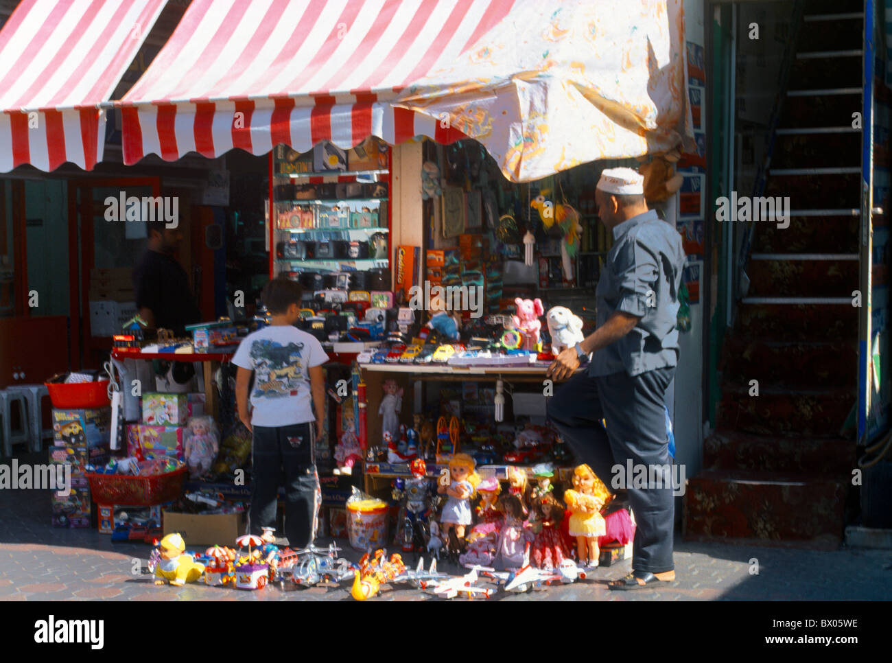 Abu Dhabi UAE People Looking At Toys In Toy Shop In Souk Stock Photo
