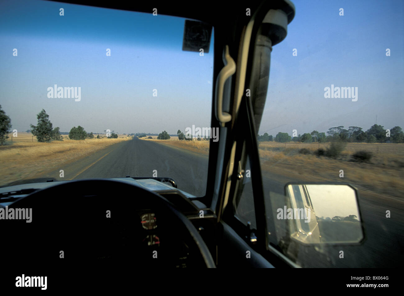 Australia automobile car desert driver´s perspective Highway Outback passenger car steering wheel street w Stock Photo