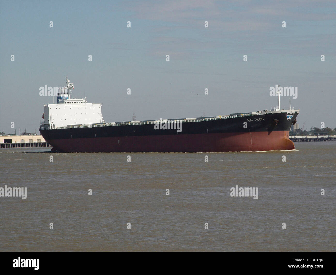 river flow freighter trade commerce industry Louisiana Mississippi Naftilos New Orleans ship shipping tr Stock Photo