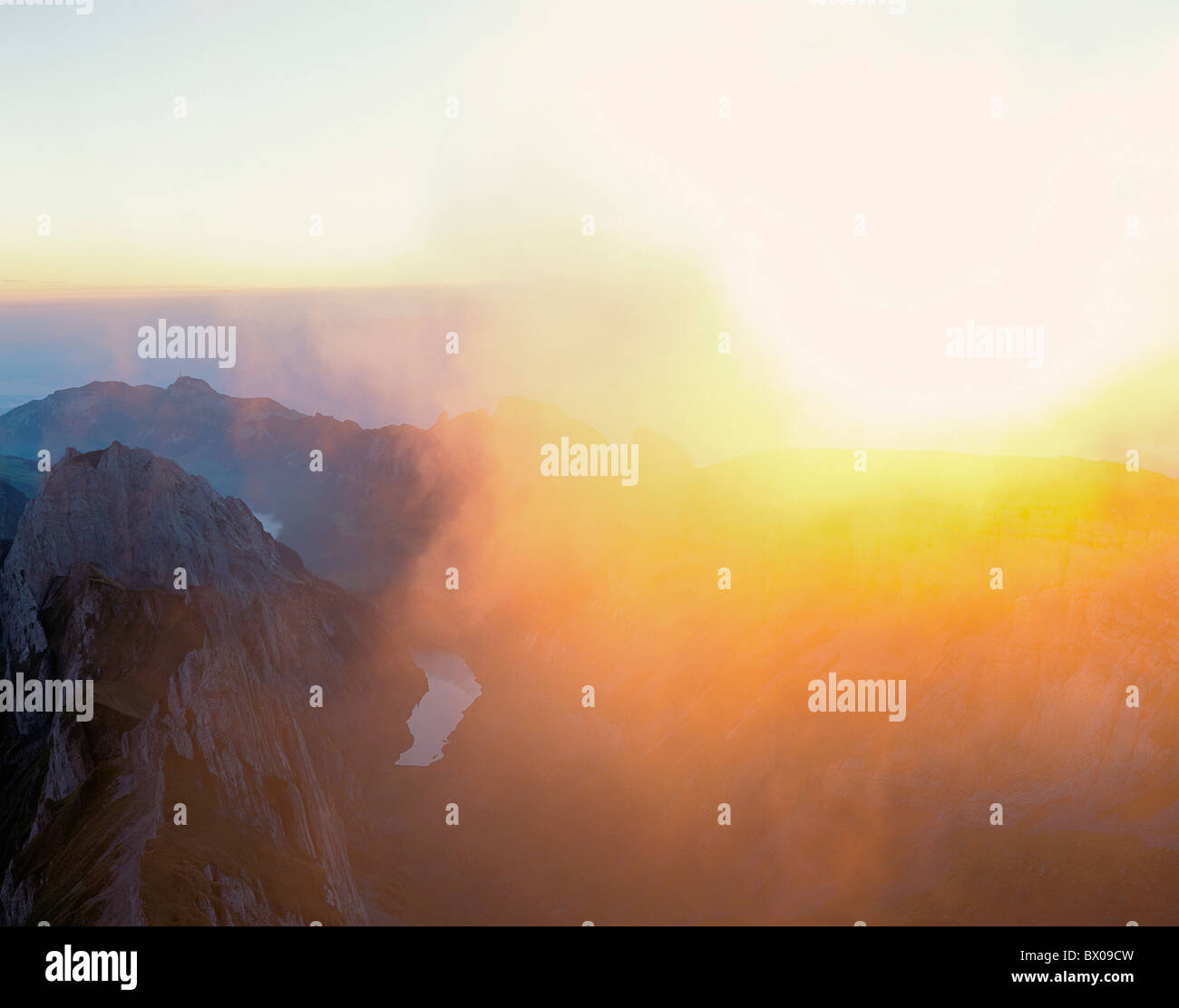 sunrise mountaintop view cloud covers mood orange Switzerland Europe Appenzell Alpstein scenery Stock Photo