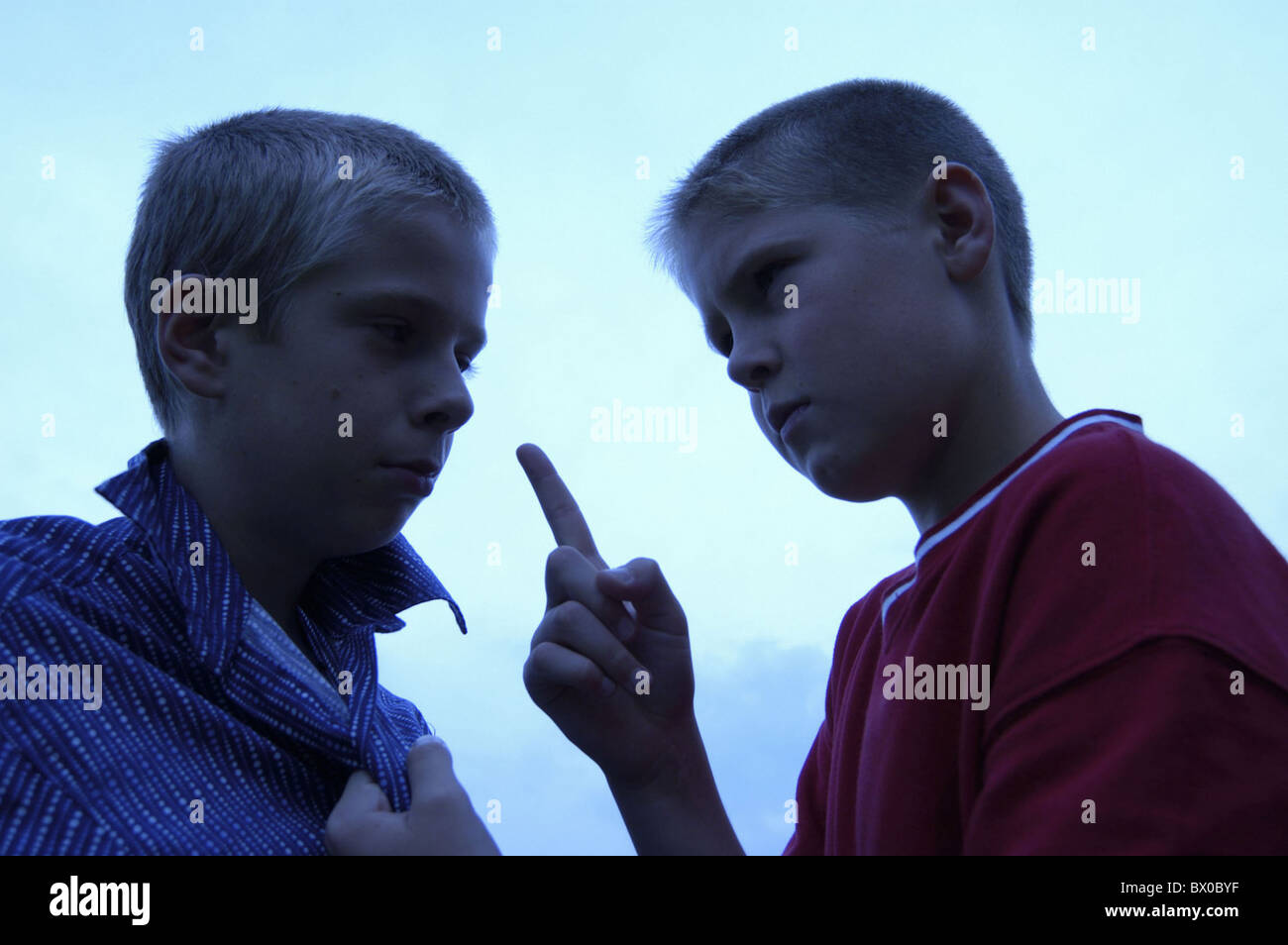 aggression aggressiv threateningly serious hint gesture children boys noise power relation problem proble Stock Photo
