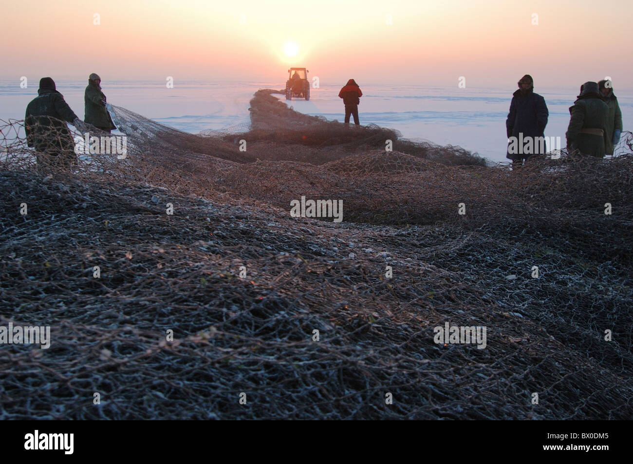 Fishermen spreading fish net during Winter Fishing, Dorbod Mongol