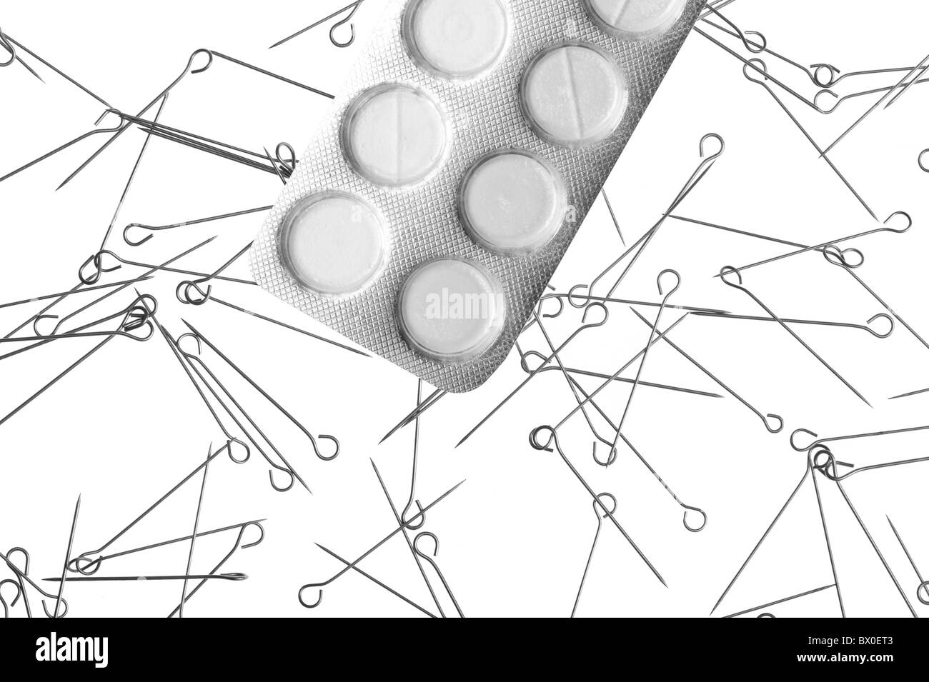 Drugs and needles on white background- metaphor of drug addiction Stock Photo