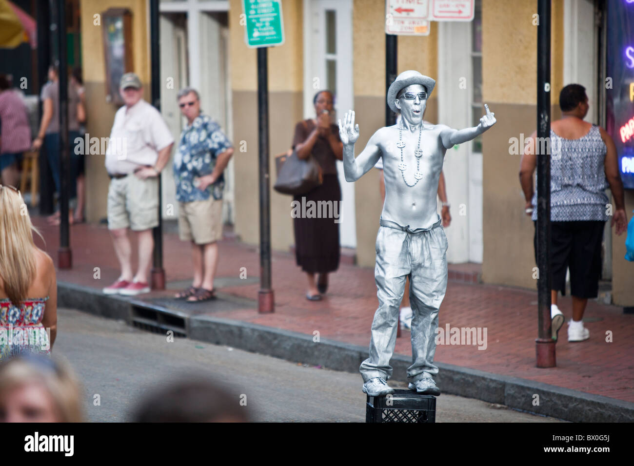 Mimes/performers painted in silver and gold pose for tips on Bourbon Street in New Orleans, Louisiana's French Quarter. Stock Photo